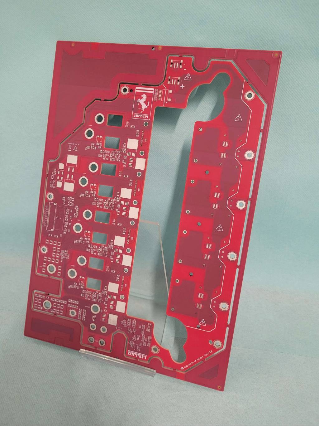 Red Printed Circuit Board (PCB) panel featuring prominent Ferrari